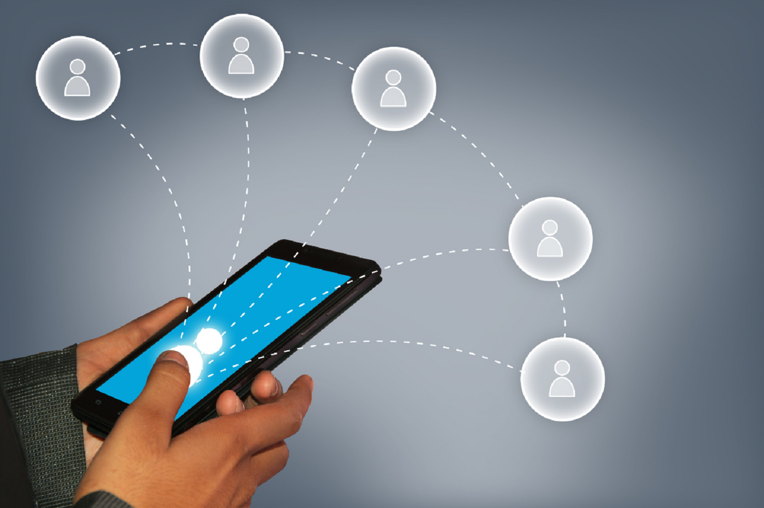 Someone holding a phone,  with user icons surrounding mid-air to demonstrate building your network on social media for the purpose of job application