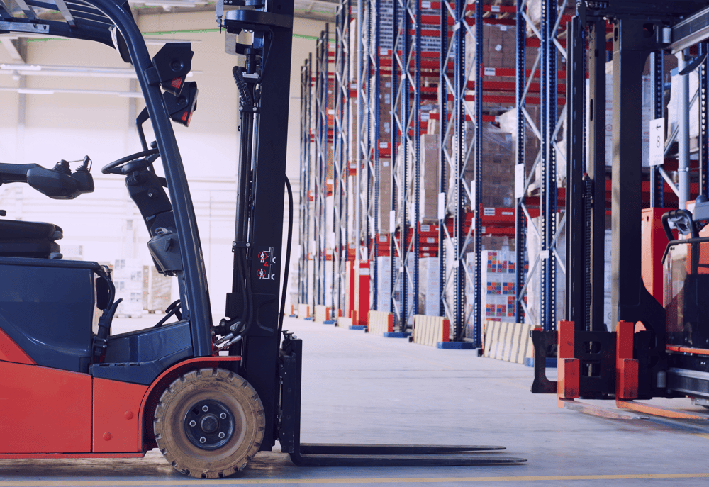 A forklift truck in a warehouse, representing jobs in logistics and supply chain management.