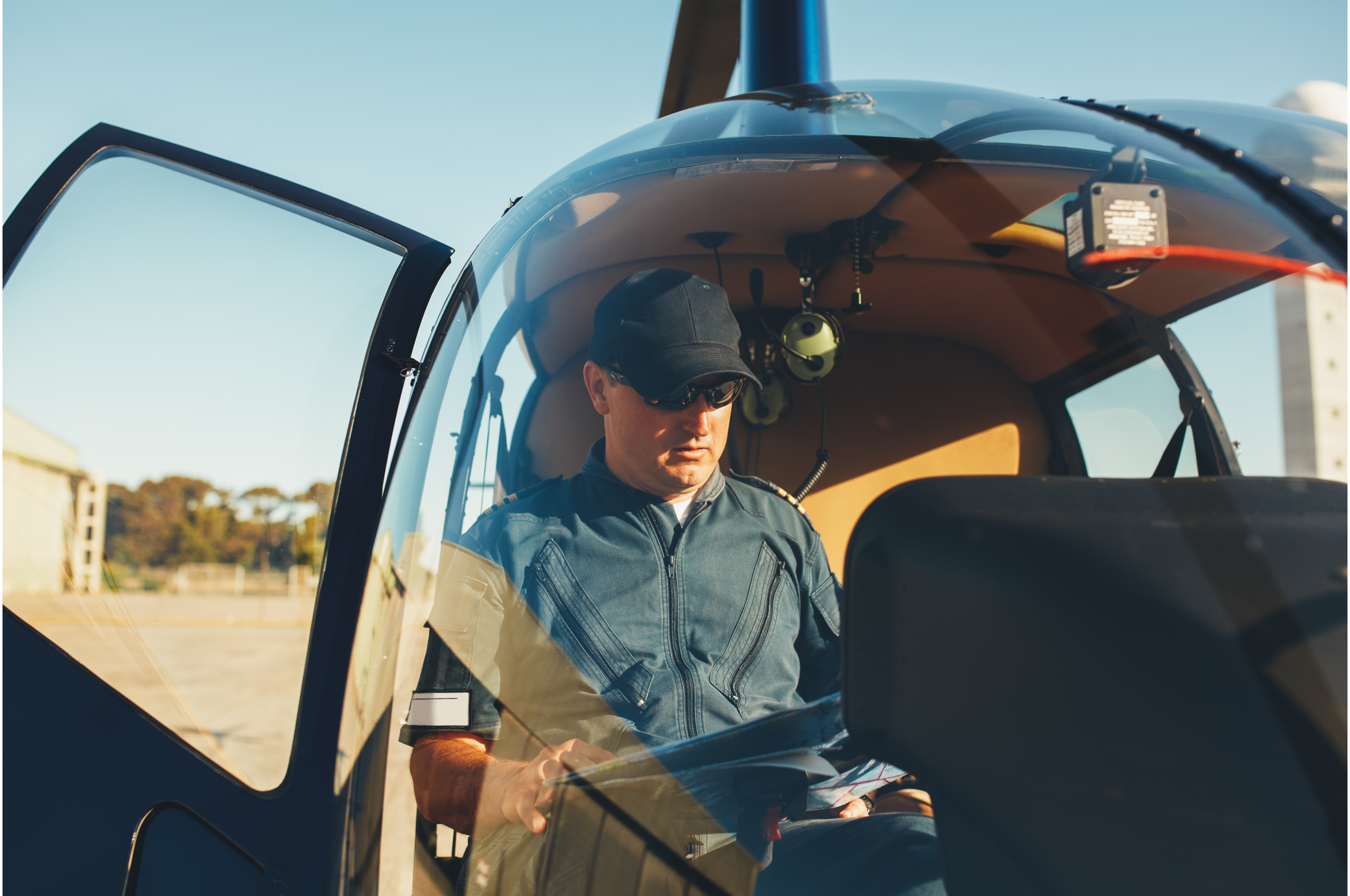 Helicopter mechanic completing checks, demonstrating aviation career opportunities with M&E 