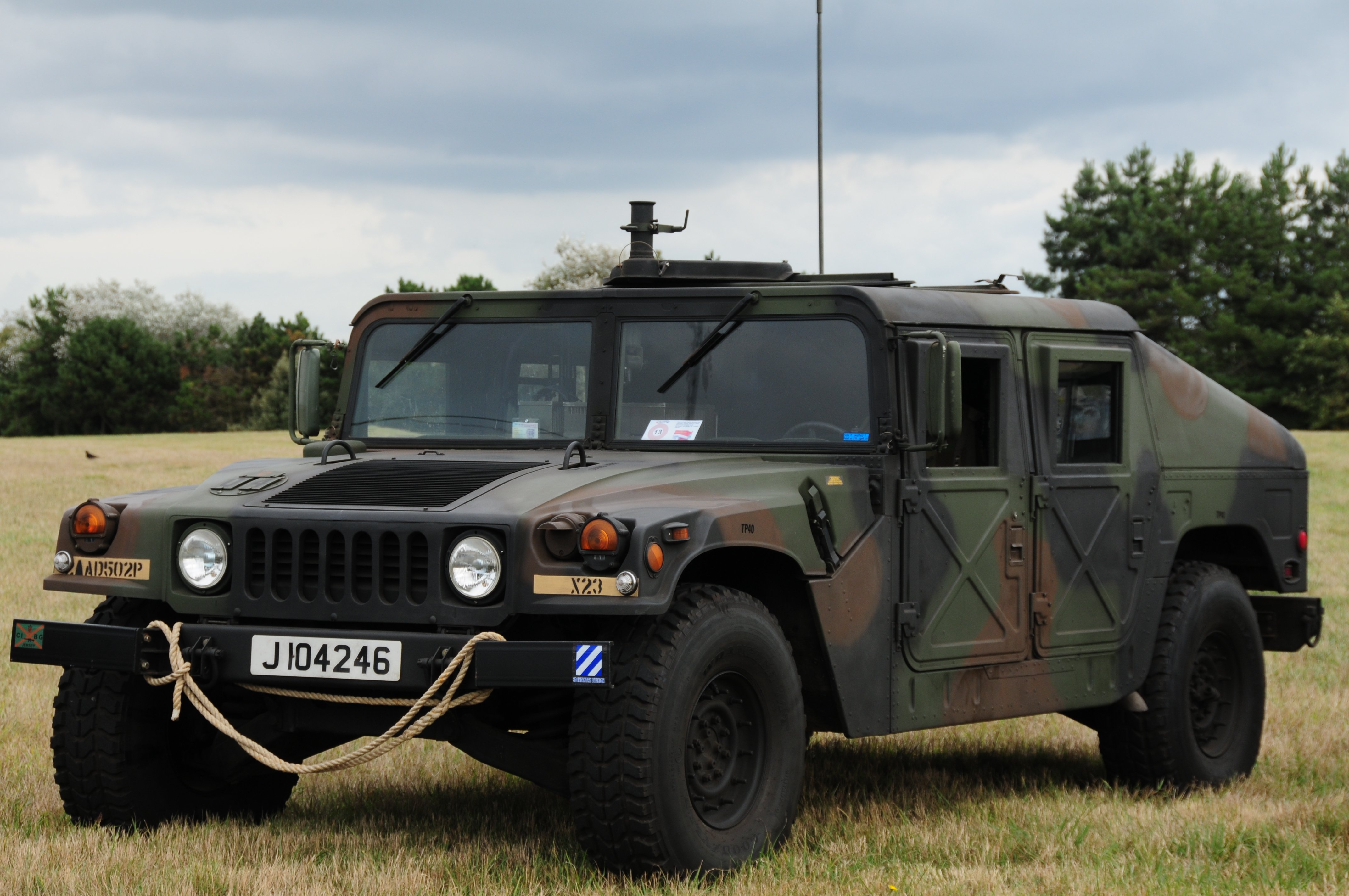 A defence land vehicle parked on the grass, representing ex-military jobs abroad.