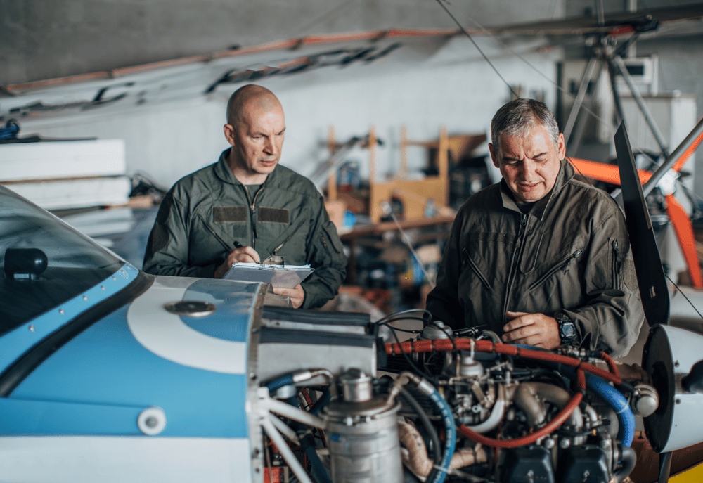 Two aviation mechanics carrying out maintenance work whilst contracting in Poland with M&E Global.