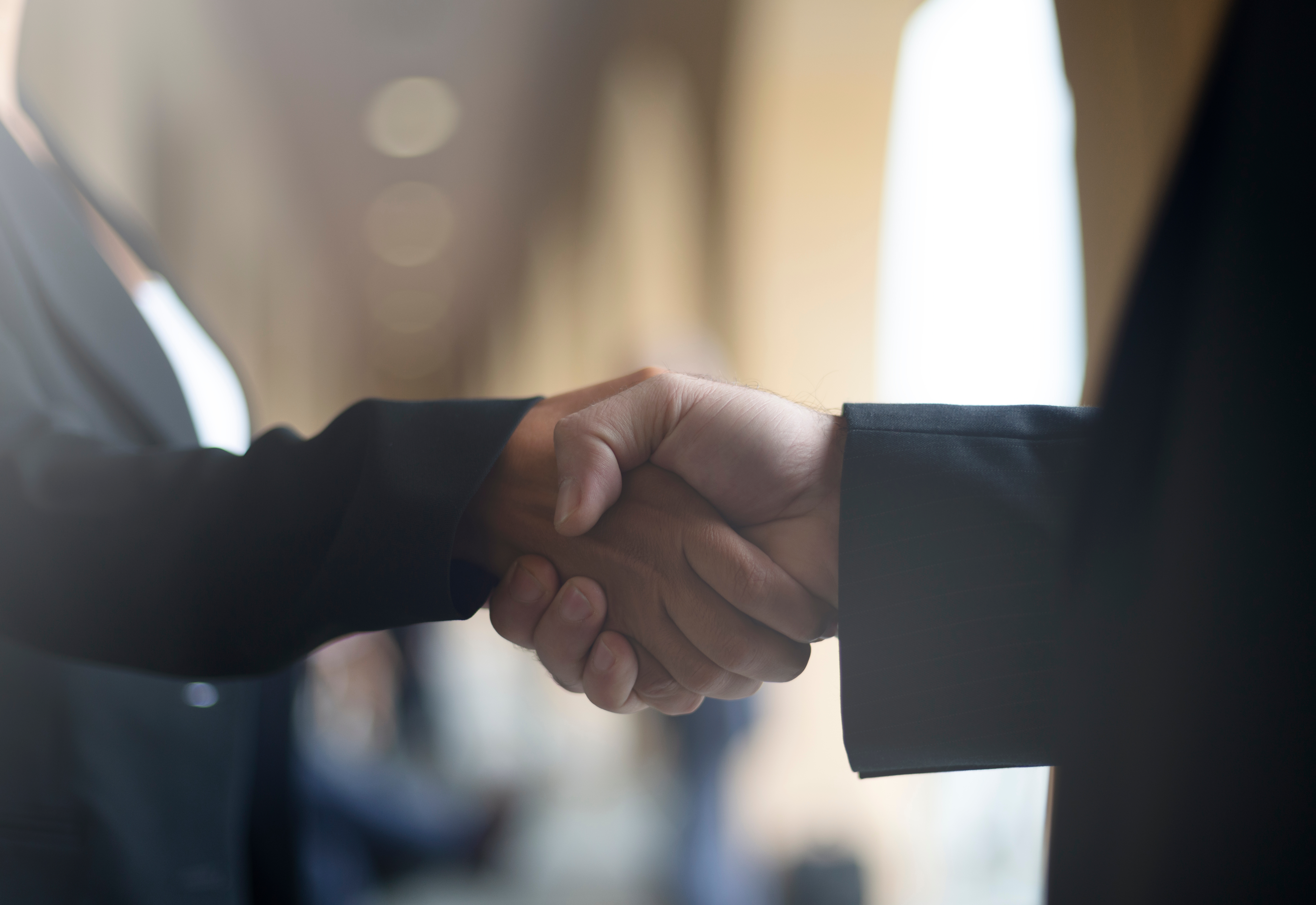 A handshake between an employer and a defence contractor after being employed for defence contract jobs overseas.