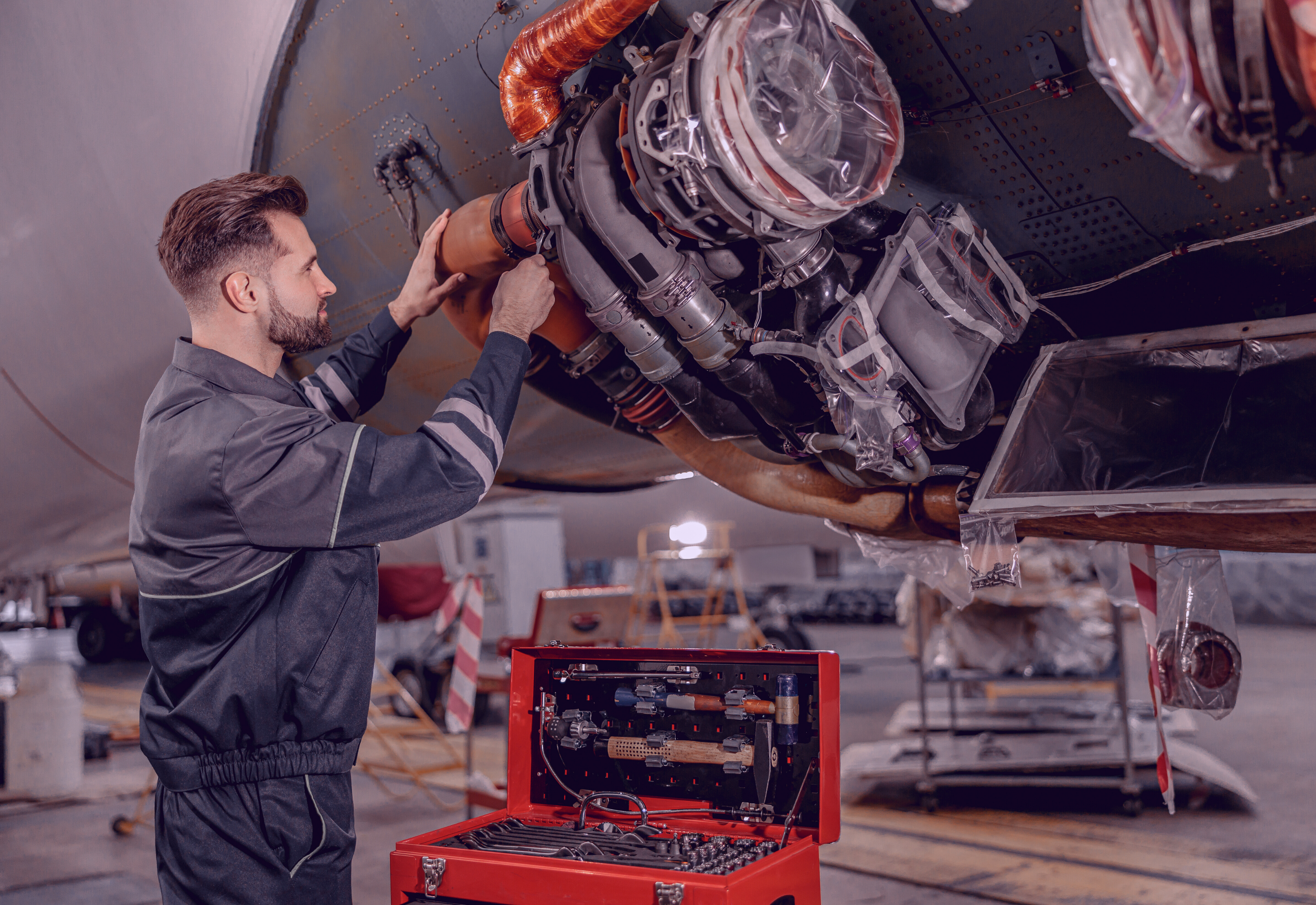 An aviation mechanic carrying out maintenance work following an aviation job search with M&E Global.